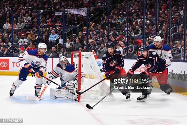 Liam Foudy of the Columbus Blue Jackets skates with the puck as Darnell Nurse of the Edmonton Oilers defends during the first period of a game at...