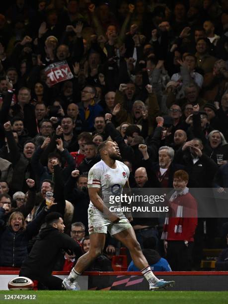 England's centre Ollie Lawrence celebrates after scoring the team's third try during the Six Nations international rugby union match between Wales...