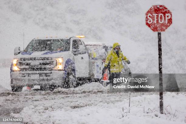 Car is towed from the snow on an onramp to the State Route 14 freeway which is shut down in both directions because of heavy snow on February 25,...