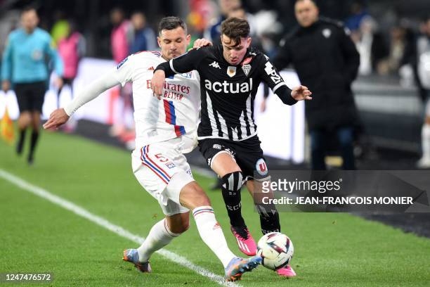 Lyon's Croatian defender Dejan Lovren fights for the ball with Angers' Franco-Gabonese forward Ulrick Eneme-Ella during the French L1 football match...