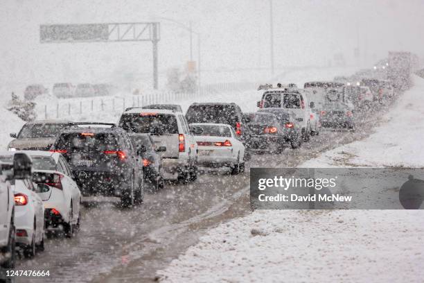Traffic backs up on a frontage road to the State Route 14 freeway when it is shut down in both directions because of heavy snow on February 25, 2023...