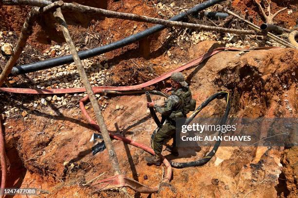 An officer of the Brazilian Institute of Environment and Renewable Natural Resources takes part in an operation against Amazon deforestation at an...