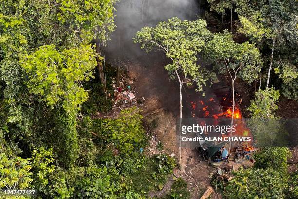 Aerial view of a house belonging to illegal miners burning in flames after being set on fire during an operation by the Brazilian Institute of...