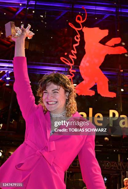 Austrian actress Thea Ehre poses with the "Silver Bear for Best Supporting Performance" for the film "Bis ans Ende der Nacht" on the red carpet after...