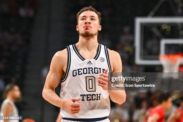 Georgia Tech guard Lance Terry leaves the court after getting hitting in the face during the college basketball game between the Louisville Cardinals...