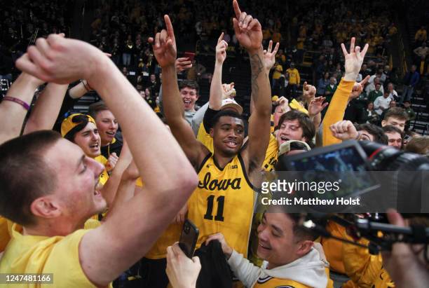 Guard Tony Perkins of the Iowa Hawkeyes celebrates with the student section after the overtime victory against the Michigan State Spartans at...
