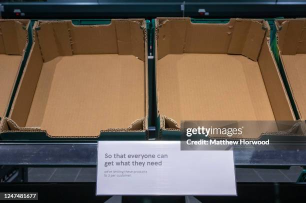 Empty shelves in a supermarket on February 25, 2023 in Cardiff, Wales. Aldi, Asda, Morrisons and Tesco have placed limits on the number of tomatoes,...