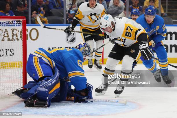 Jordan Binnington of the St. Louis Blues makes a save against Sidney Crosby of the Pittsburgh Penguins in the second period of the game at Enterprise...