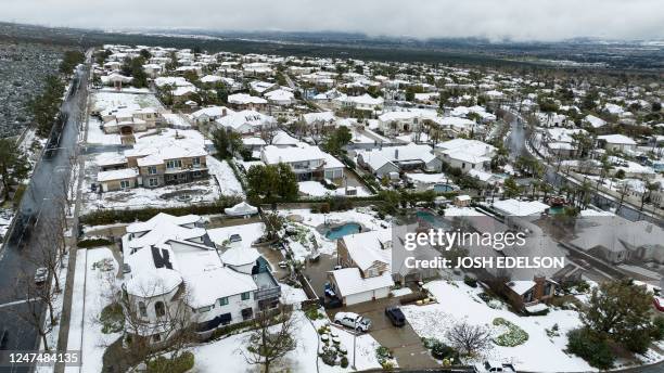 Snow covers homes in the Haven Estates neighborhood of Rancho Cucamonga, California, on February 25, 2023. - Heavy snow fell in southern California...