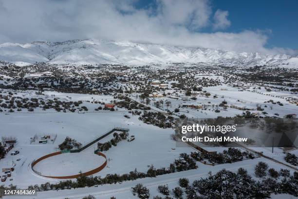 In an aerial view, snow covers the land near the State Route 14 freeway, which was shut down in both directions during a snowstorm on February 25,...