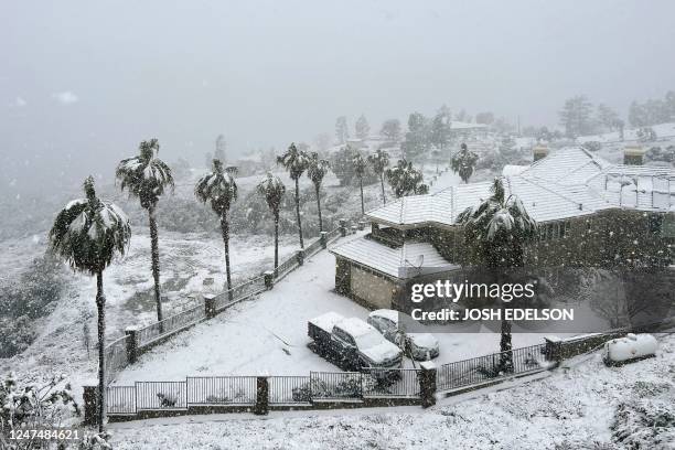 Snow blankets a home in Rancho Cucamonga, California, on February 25, 2023. - Heavy snow fell in southern California as the first blizzard in a...