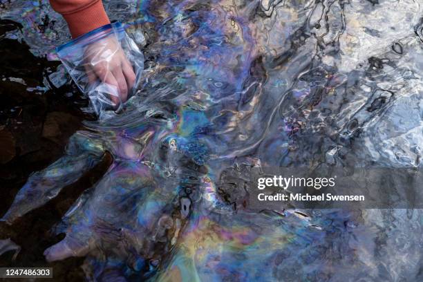 Olivia Holley and Taylor Gulish collect water samples from Leslie Run creek on February 25, 2023 in East Palestine, Ohio. Holley and Gulish are...