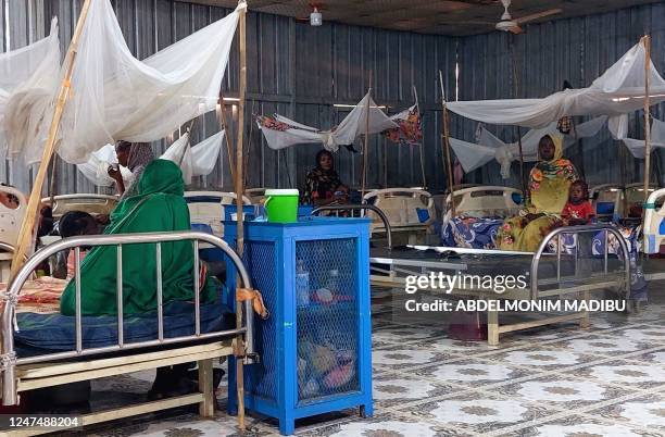 Women and a children sit waiting at a nutrition centre at the Kalma camp for the displaced just outside Nyala, the provincial capital of South Darfur...