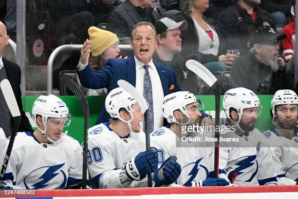 Head coach Jon Cooper, standing, of the Tampa Bay Lightning yells to his team as they played against the Detroit Red Wings in the first period of an...