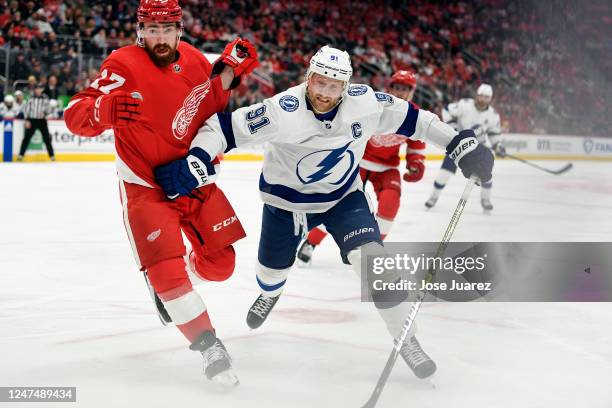 Filip Hronek of the Detroit Red Wings and Steven Stamkos of the Tampa Bay Lightning go for the puck in the second period of an NHL game at Little...