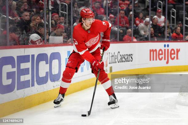 Moritz Seider of the Detroit Red Wings skates with the puck against the Tampa Bay Lightning in the second period of an NHL game at Little Caesars...