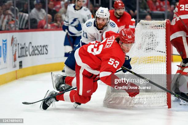 Moritz Seider of the Detroit Red Wings falls to the ice in front of Brayden Point of the Tampa Bay Lightning in the second period of an NHL game at...