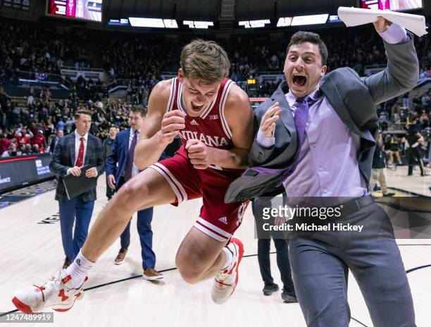 Miller Kopp of the Indiana Hoosiers celebrates with grad assistant Isaac Green following the game against the Purdue Boilermakers at Mackey Arena on...