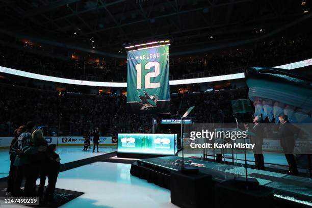 The Patrick Marleau jersey banner is raised to the rafters during the pregame ceremony to retire his number before a game between the Chicago...