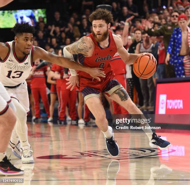 Logan Johnson of the St. Mary's Gaels drives against Malachi Smith of the Gonzaga Bulldogs during the first half of the game at McCarthey Athletic...