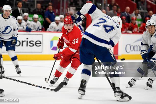 Jonatan Berggren of the Detroit Red Wings watches as Zach Bogosian of the Tampa Bay Lightning loses control of the puck in the third period of an NHL...