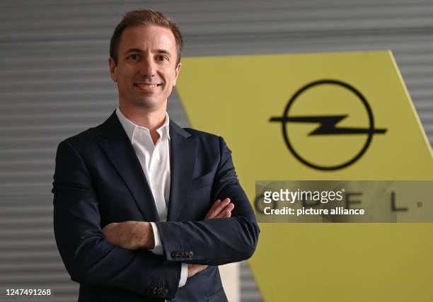 February 2023, Hesse, Rüsselsheim: Florian Huettl, Managing Director of Opel Automobile GmbH, stands in front of an Opel brand logo at the company's...