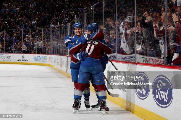 Logan O'Connor, Alex Newhook and Andrew Cogliano of the Colorado Avalanche celebrate a goal against the Calgary Flames at Ball Arena on February 25,...