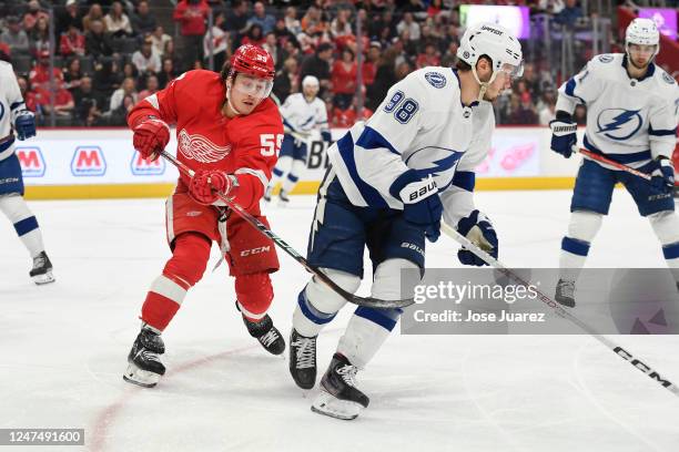 Tyler Bertuzzi of the Detroit Red Wings tries to slow down Mikhail Sergachev of the Tampa Bay Lightning in the first period of an NHL game at Little...
