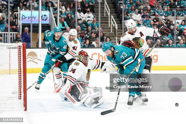 Noah Gregor of the San Jose Sharks battles for the puck against Seth Jones of the Chicago Blackhawks at SAP Center on February 25, 2023 in San Jose,...