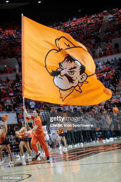 Oklahoma State Cowboys cheer squad carries a school flag during a break in play in the game against the Kansas State Wildcats on February 25th, 2023...