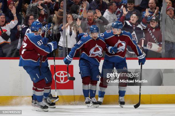 Matt Nieto, Alex Newhook, Denis Malgin and Josh Manson of the Colorado Avalanche celebrate a goal against the Calgary Flames at Ball Arena on...