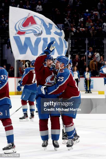 Samuel Girard and Logan O'Connor of the Colorado Avalanche celebrate a win against the Calgary Flames at Ball Arena on February 25, 2023 in Denver,...