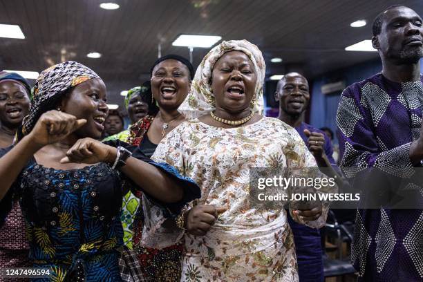 Worshippers sing and dance during celebrations after a peaceful voting day at the Foursquare Gospel Church in Lagos, on February 26 the day after...