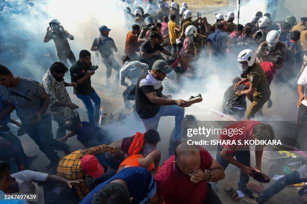 Police fire tear gas to disperse activists of the opposition National Peoples Power party during a protest held to urge the government to hold local...