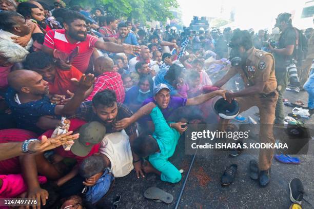 Police fire tear gas to disperse activists of the opposition National Peoples Power party during a protest held to urge the government to hold local...