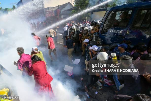 Police use water cannons and tear gas to disperse activists of the opposition National Peoples Power party during a protest held to urge the...