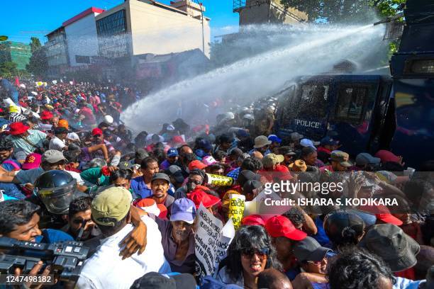 Police use water cannons and tear gas to disperse activists of the opposition National Peoples Power party during a protest held to urge the...