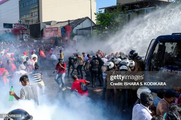 Police use water cannons and tear gas to disperse activists of the opposition National Peoples Power party during a protest held to urge the...