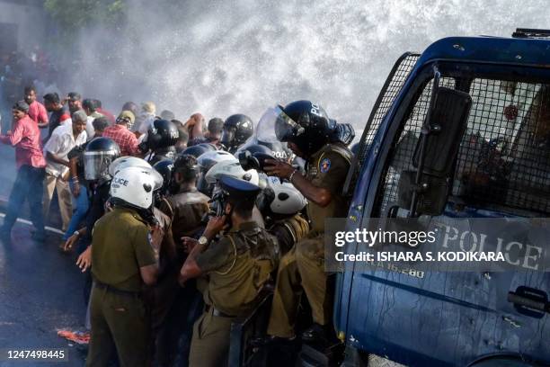 Police use water cannons and tear gas to disperse activists of the opposition National Peoples Power party during a protest held to urge the...