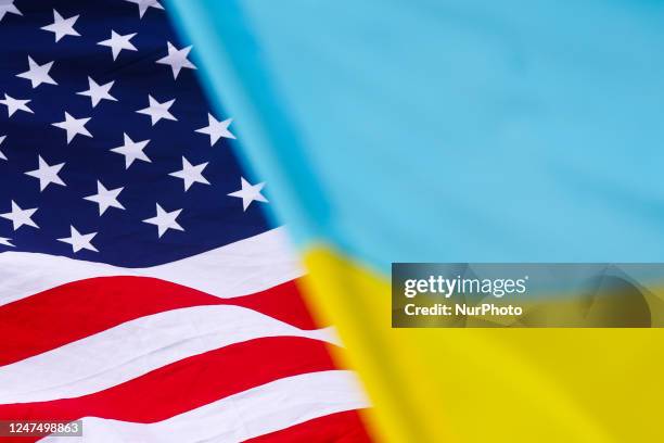 The national flag of the United States of America and Ukrainian flag are seen during a daily demonstration of solidarity with Ukraine at the Main...