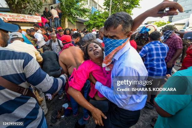 Police use water cannons and tear gas to disperse activists of the opposition National Peoples Power party during a protest held to urge the...