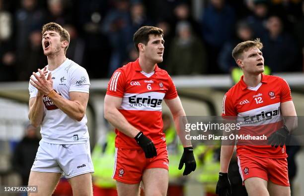 Kildare , Ireland - 26 February 2023; Kevin Feely of Kildare reacts after kicking a wide as Derry players Padraig McGrogan and Ethan Doherty look on...