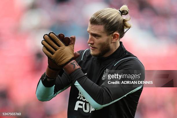 Newcastle United's German goalkeeper Loris Karius applauds the fans as he warms up ahead of the English League Cup final football match between...