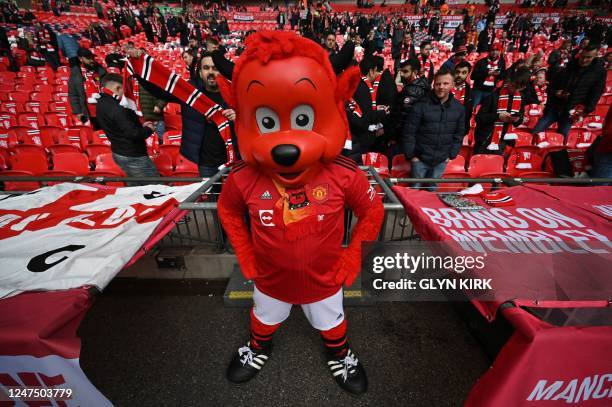 Manchester United's macsot Fred the Red poses with fans ahead of the English League Cup final football match between Manchester United and Newcastle...