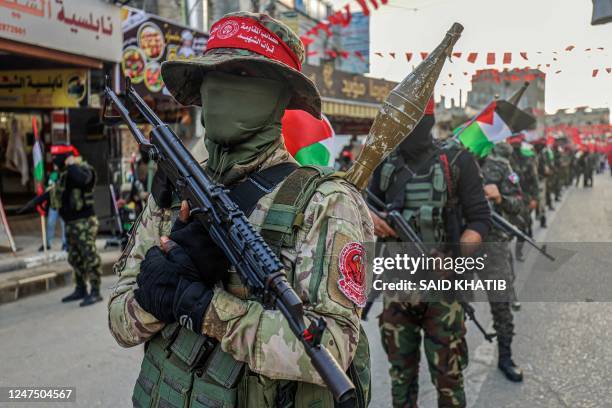 Masked Palestinian militants of the Democratic Front for the Liberation of Palestine take part in a parade in Rafah town in the Southern Gaza Strip,...