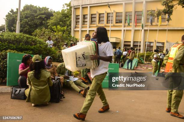 Independent National Electoral Commission officials carrying ballot boxes to polling unite, during the Nigeria Presidential election at a polling...