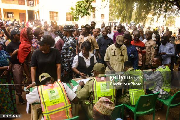 Voters wait on the queue to cast their votes during the Nigeria Presidential election at a polling station at the Federal Capital Territory, Abuja on...