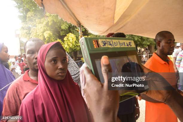Official of the Independent National Electoral Commission uses the Bimodal Voter Accreditation System during the Nigeria Presidential election at a...