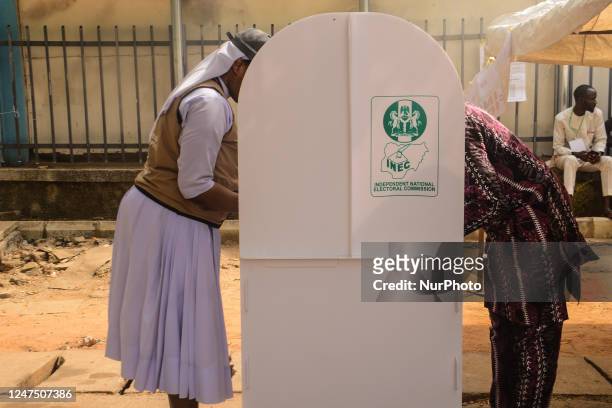 Voters cast their ballots at a polling unit during the Nigeria Presidential election at a polling station at the Federal Capital Territory, Abuja on...