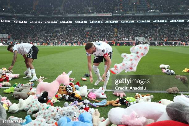 Teddy bears and toys thrown on the field to be sent to the earthquake zone of the Vodafone Park Stadium prior to the Turkish Super Lig soccer match...